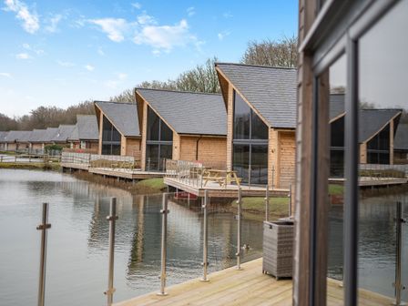 A view of cabins next to a lake at Tranquillity 4 in Carnforth