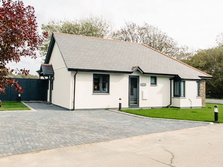 A house with a driveway and garden at Cornish Lodge Spa in Bude