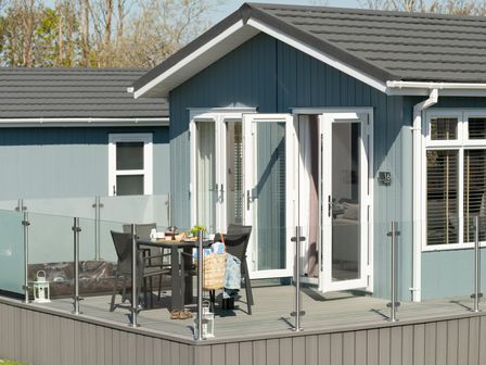 An outdoor area with a table and chairs at Kynance Spa in Bude