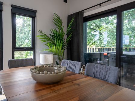 A dining room with a wooden table and chairs at Cabin 3.0 (Pet) Dumfries