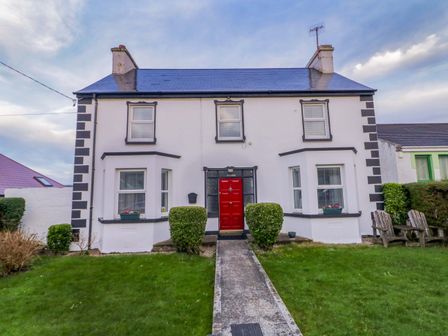 A house exterior with a red front door at San Antonio in Dungloe, County Donegal