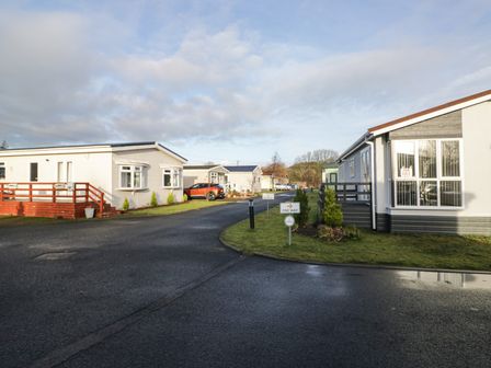 A view of mobile homes and road at Beechtree Timber Lodge 69A in Denny