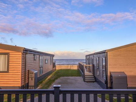 An outdoor view of cabins near the ocean at Paws By The Sea in Norwich