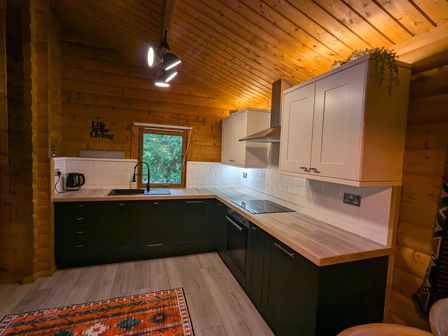 A kitchen with a sink and stove at Pineshadow Lodge in Louth