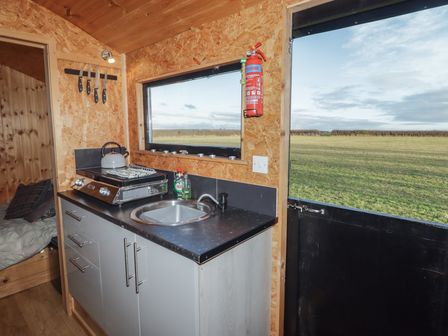 A kitchen area with sink and stove at Rhosgranog Shepherds Hut in Llandeloy near Solva