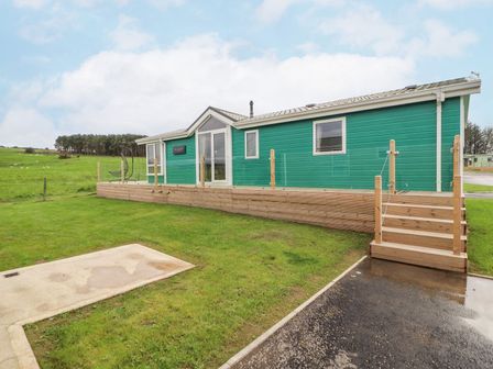 A house with a deck and steps outside at No 8 Hillcote Lodge in Cockermouth