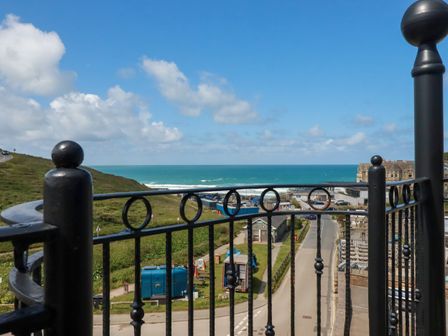 A view of the ocean and landscape from a balcony at Lowenna Watergate Bay near Newquay