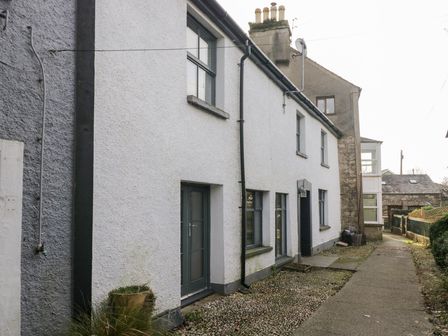 An exterior view of a residential building with windows and a path at No.2 The Flags, Grange-over-Sands