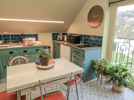 A kitchen with a table and chairs at Golden Valley View in Stroud