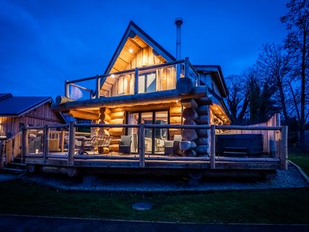 A log cabin with a deck and chairs at The Lookout in Addingham