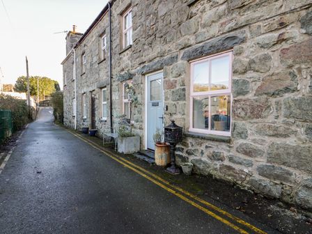 A stone exterior of a house with windows and door at Lon Popty Dolgellau