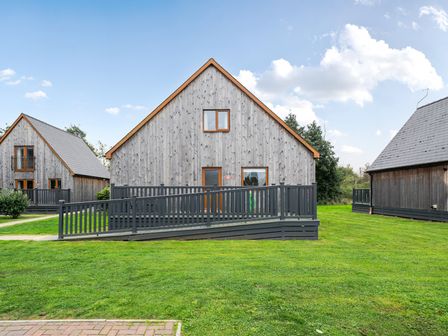 A house with a ramp and lawn at Lodge 14 - Pebbles Brigg