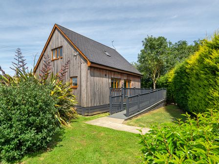 A house with a deck and garden at James Ville Marina Lodge 10 in Brigg