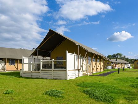 A tent structure with a deck in a grassy area at Kruger (Pet) Penrith