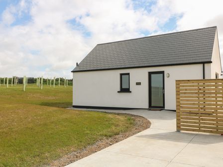 A house with a pathway and fence at Radharc an Hook @ Estuary Bliss