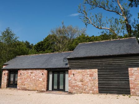 A building with stone walls and windows at The Heronry in Carlisle