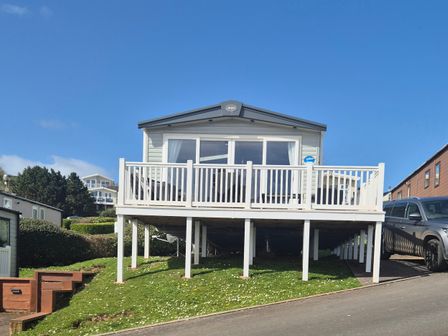 A house with a deck and car parked nearby at 21 Gorse Hill in Exmouth