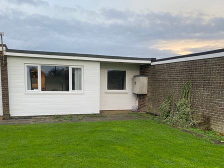 An exterior view of a house with grass at Chalet 333 in California, Norfolk
