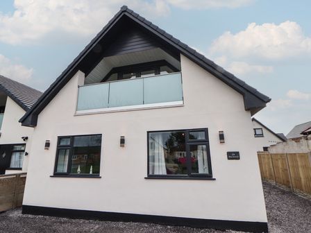 A house with windows and a balcony at Mike’s Place in Rhyl