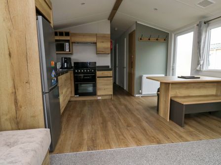 A kitchen with appliances and a dining area at Valley 36 in Kingsbridge