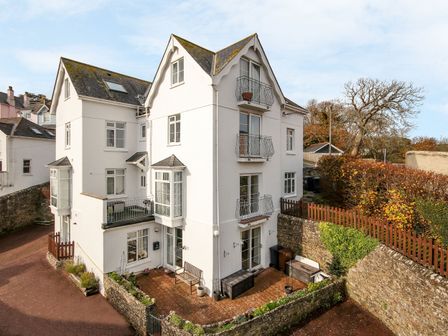 An exterior view of a building with a patio at 3 The Elms in Salcombe