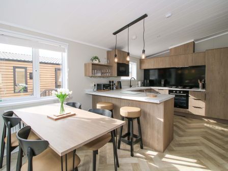 A kitchen with a table and chairs at Tulip in Eardisland