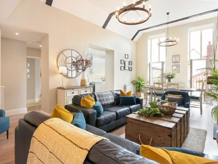A living room with a sofa and coffee table at Juniper Cottage