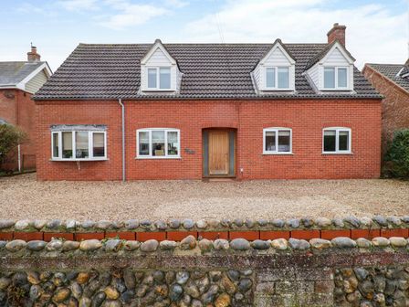 A house with windows and a door at Cliff Cottage