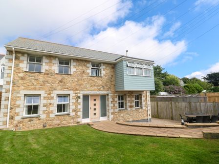 A house with windows and a patio at Rosevale Villa in St Ives