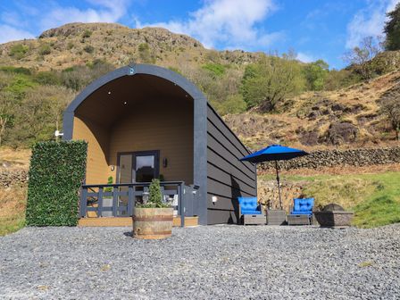 An outdoor cabin with a deck and seating area at Bluebelle - Crossgate Luxury Glamping Hartsop