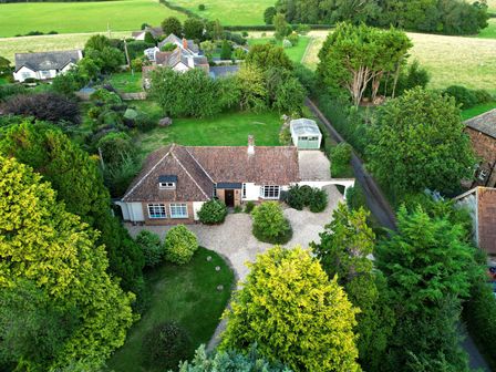 An aerial view of a house with a garden and driveway at Barton Lodge in Porlock