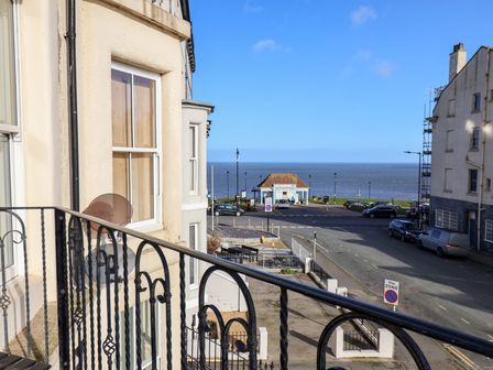 A balcony view of the ocean and street at Masons Place in Whitby