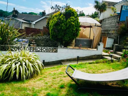 A garden with plants and a hot tub at House - Sleeps 7 - Garden - Pets Ok - Parking in Torquay