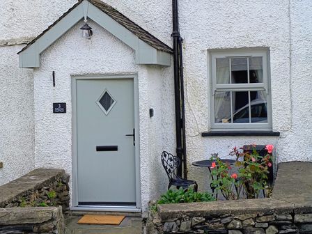 An entrance with a door and flowers at Bobbin Nook in Staveley