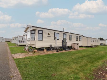 A mobile home with steps and outdoor chairs at Winchester - 244