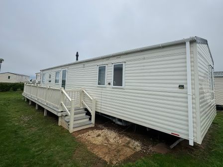 A mobile home with a deck and steps at Harbour Watch 22 Watchet