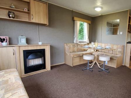 A living room with a dining area and a sofa at tbc in 