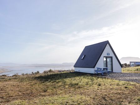 A cabin with a table and bench outdoors at Cabin 10 Inish Bo Finne in Gortahawk