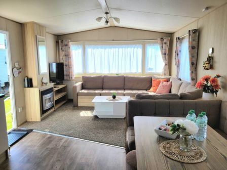 A living room with a couch and coffee table at St Osyth- Sleeps8-freeparking-wifi-holidaypark in Clacton-On-Sea