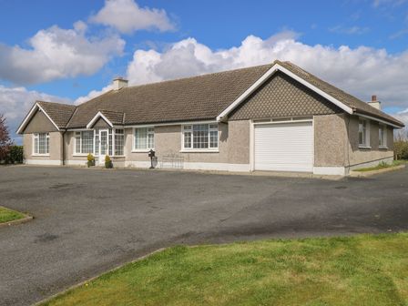 A house with a garage and driveway at Marie's Country Home in Ardee, County Louth