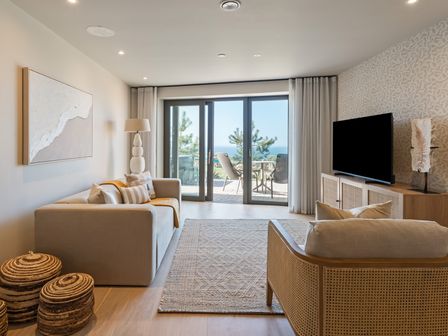 A living room with a television and a sofa at tbc in St. Ives