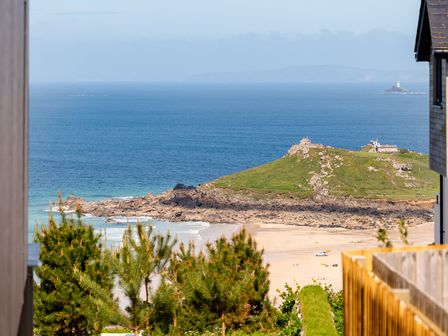 A coastal view with hills and sea at Hidden 7- Coastal Loft St Ives
