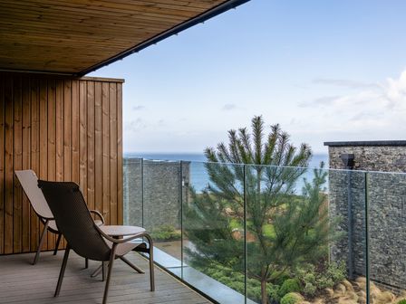 An outdoor area with two chairs and an ocean view at tbc St. Ives
