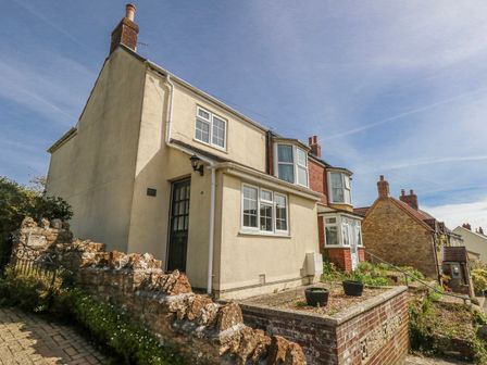 A house with a garden and stone wall at 12 West Street Weymouth