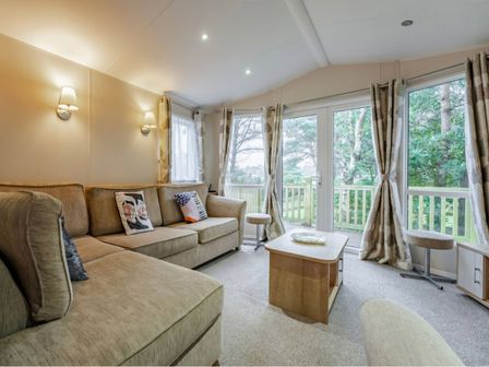 A living room with a sofa and coffee table at Bingos Cabin in Holt