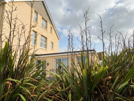 A building with windows and bushes at 8 Yellow Sands in Padstow