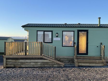 A static caravan with steps and a handrail at Beautiful 2 Bed Static caravan in