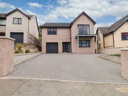 A house with a driveway and balcony at 95 Cae America Llanfairfechan