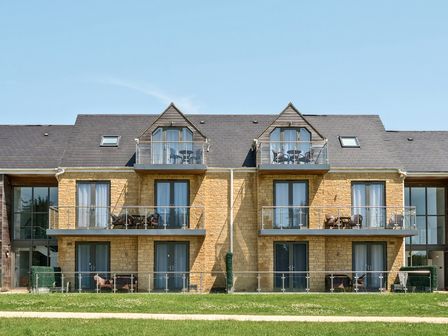 A building with balconies and glass railings at Cotswolds Apartments 4B/S8 in Chipping Norton