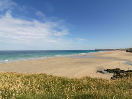 A beach with sand and water at Roslenn in St Agnes